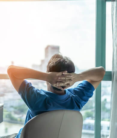 man looking out of office window